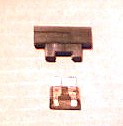 A typical fuseblock. The fuse is shown removed and simply clips into the block, connecting the two terminals.